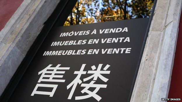 The door of a real estate office with Chinese characters announcing properties to sell in downtown Lisbon is pictured in November 2013
