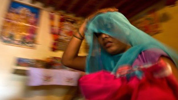 Alleged victim of human trafficking in India, leaving with her belongings after being rescued
