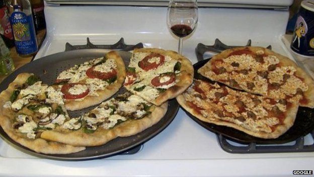 Two pizzas sitting on top of a stove top oven