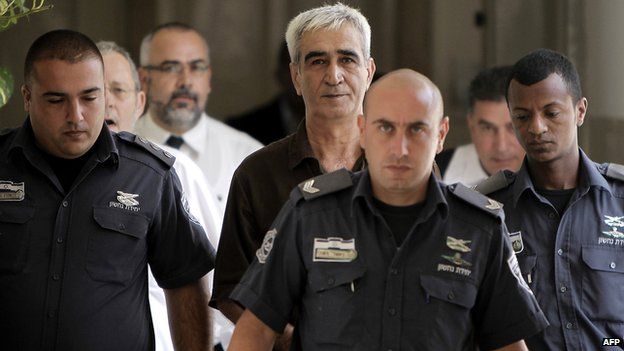 Ahmed Saadat (C) is escorted by Israeli police as he arrives to attend a hearing in his trial at a court in Jerusalem in September 2012