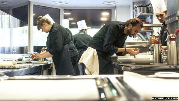 French star TV chef Cyril Lignac (R) at his restaurant Le Quinzieme in Paris