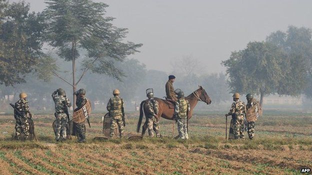 Indian police personnel gather some two kilometres from the ashram of self-styled "godman" Rampal Maharaj in Hisar, some 175 kilometres (108 miles) north of New Delhi on November 19, 2014