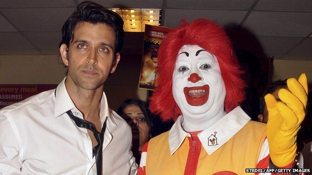 Indian Bollywood actor Hrithik Roshan (L) poses with Ronald McDonald the clown