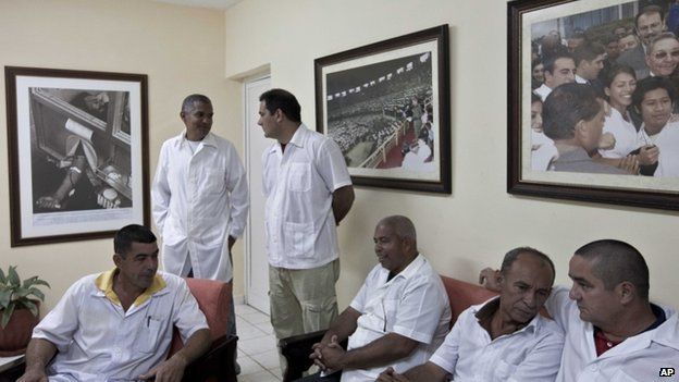 Cuban doctors who will travel to Liberia and Guinea, wait for the start of a press event in Havana, Cuba, Tuesday, Oct. 21, 2014.