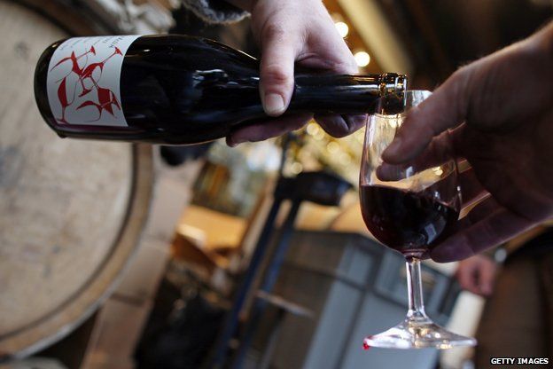 Wine is poured from a bottle of Beaujolais Nouveau