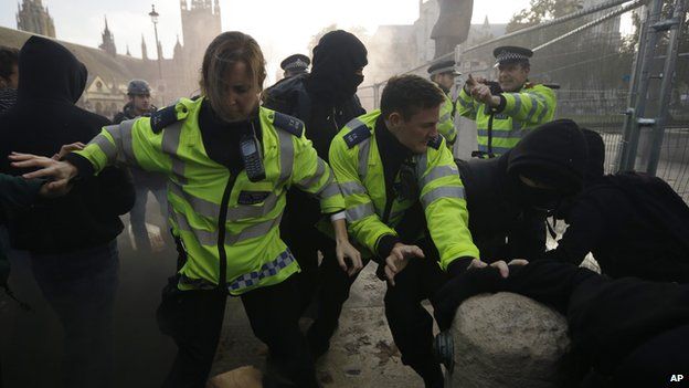 British police officers and students clash on Parliament Square during a protest against university tuition fees
