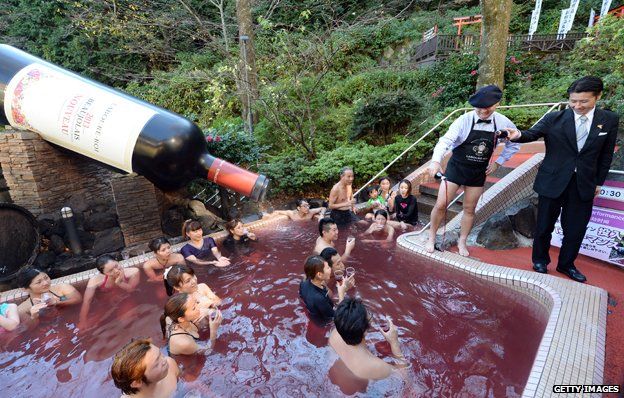 Beaujolais Nouveau wine is poured into the wine spa at the Hakone Yunessun spa in Hakone town, Japan