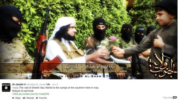 Screen grab from an Islamic State group affiliated Twitter account, taken 20 September 2014 purports to show senior military commander Abu Wahib handing a flower to a child while visiting southern Iraq