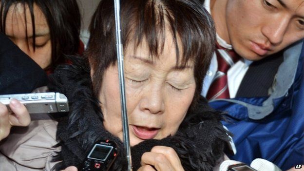 In this photo taken in March, Chisako Kakehi is surrounded by reporters in Sakai, western Japan.