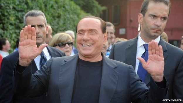 Silvio Berlusconi waves at a public appearance