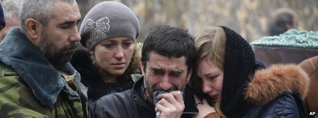 Mourners at the funeral on 7 November of two schoolboys killed by shelling in Donetsk