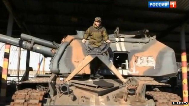 Young man on top of a tank