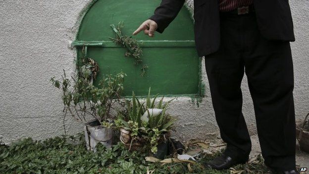 A man stands in front of the grave of 13-year-old Suhair al-Bataa