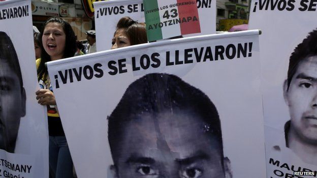 Bolivian students hold banners, with photographs of missing Mexican students, during a rally in support their support in La Paz, on 20 November 2014.