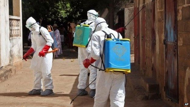 Health workers spray disinfectant a street in Bamako, Mali. Photo: November 2014