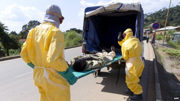 Health workers take a patient to an Ebola treatment centre, Macenta, Guinea, 21 November 2014
