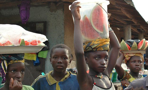 Children selling watermelon slices in Guinea, 21 November 2014