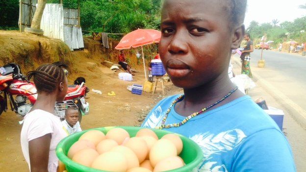 A woman sells eggs at a checkpoint, Sierra Leone, 21 November 2014