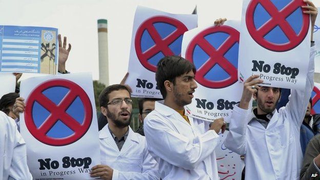 Iranian students hold placards to show their support for Iran's nuclear programme in a gathering in front of the headquarters of Iran's Atomic Energy Organization in Tehran, Iran, 23 November 2014
