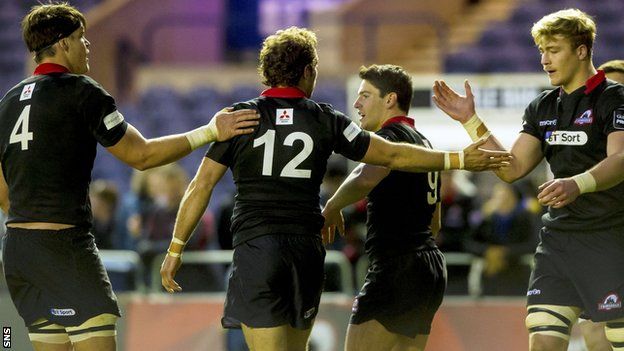 Andries Strauss (centre) celebrates scoring a try for Edinburgh