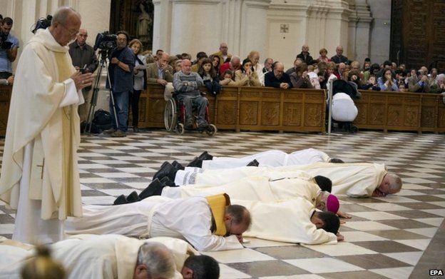Granada's Archbishop, Francisco Javier Martinez, and other clerics prostrate themselves in front of Granada cathedral's high altar to ask forgiveness for alleged sexual abuses committed by priests on 23 November 2014.