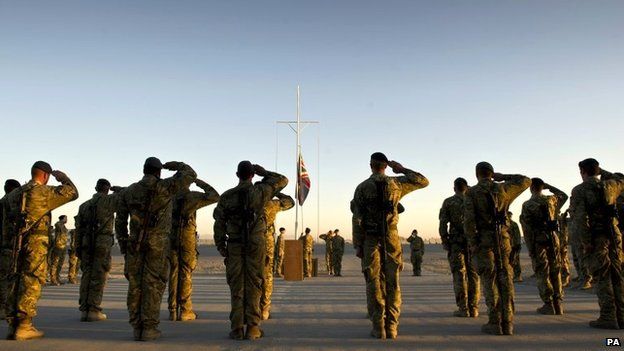 Garrison Sergeant Major (GSM) WO Andrew Stephens (RAF) lowering the Union flag for the last time at Kandahar Air base, Afghanistan