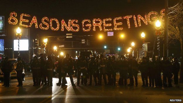 Police form a line in the street under a holiday sign after a grand jury returned no indictment in the shooting of Michael Brown in Ferguson, Missouri November 24, 2014.