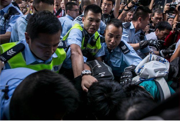 Police clash with protesters as they try to clear the street after agents authorized by bailiff's removed barricades on Argyle Street in Mongkok district on November 25. 2014
