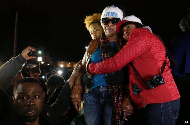 Mr Brown's mother, Lesley McSpadden, is comforted by supporters in Ferguson, 24 November