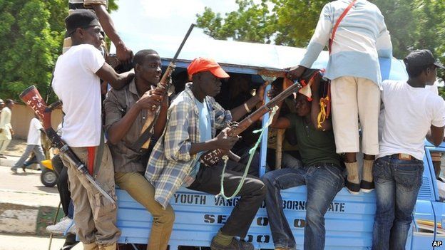 Vigilante and local hunters armed with guns patrol the streets of Maiduguri, Nigeria, on 4 September 2014