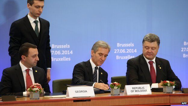 Georgian Prime Minister Irakli Garibashvili (left), Moldovan Prime Minister Iurie Leanca (second right) and Ukrainian President Petro Poroshenko (right) attend the second day of the EU summit on 27 June 2014 in Brussels.
