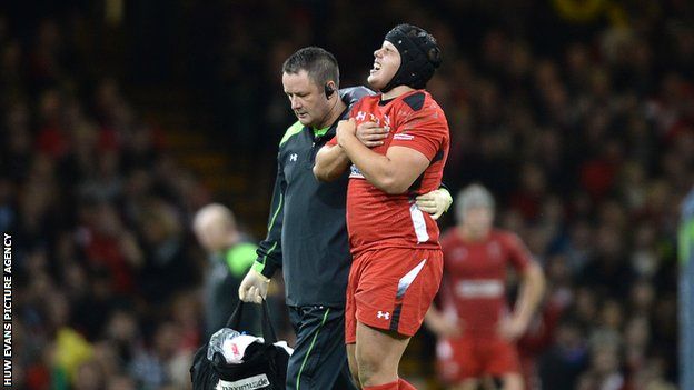 Wales prop Nicky Smith is helped off the field in pain