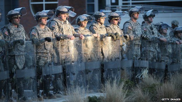 Soldiers with the Missouri National Guard stand guard outside the Ferguson police station on 25 November 2014 in Ferguson, Missouri