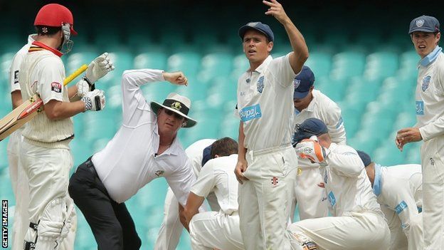 Phil Hughes is attended to after being hit by the ball. 25 Nov 2014