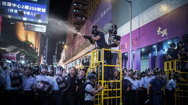 Police use pepper spray as they clear a road at a pro-democracy protest site in the Mongkok district of Hong Kong on November 25, 2014
