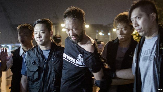 Civic Party member Ken Tsang, one of Hong Kong's pro-democracy political groups, is taken away by policemen, before being allegedly beaten up by police forces