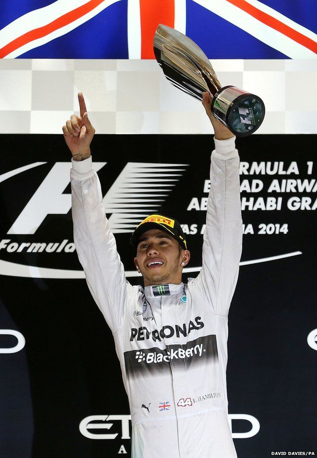 Lewis Hamilton holds the trophy