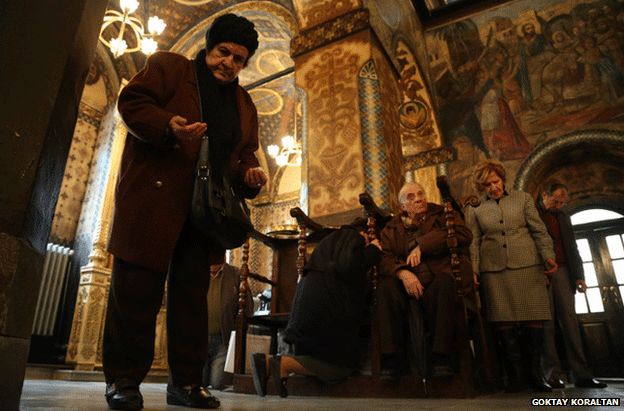 People praying in an Orthodox Christian church in Turkey