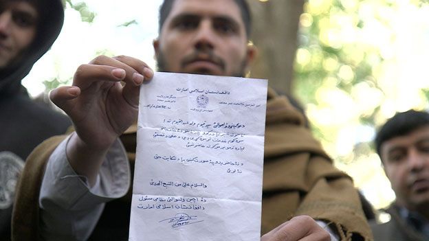 An interpreter holding a typical letter from the Taliban threatening to kill him