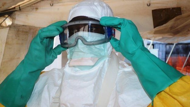 A health worker in Conakry, Guinea, wearing protective clothing