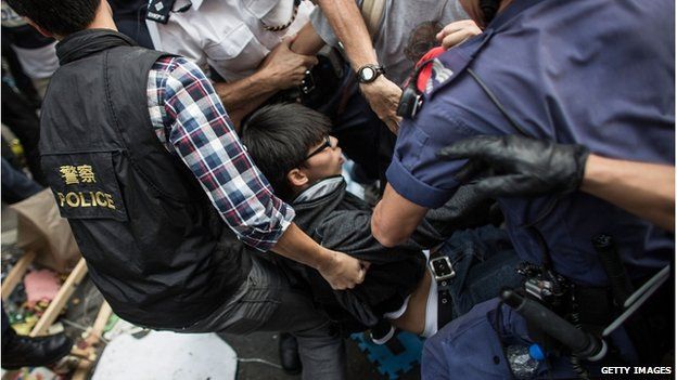 Police officers arrest Joshua Wong, student leader, in the Mong Kok district on November 25, 2014 in Hong Kong.