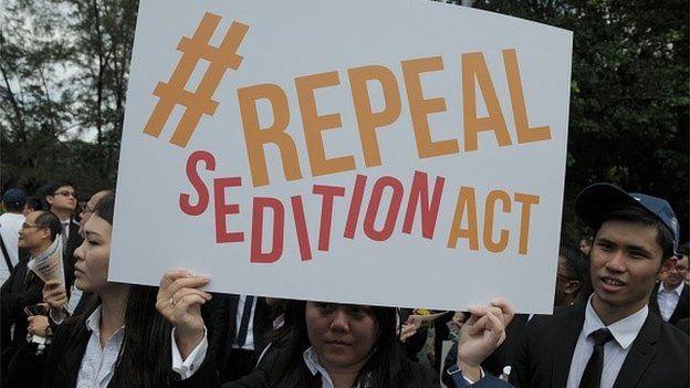 In a photo taken on October 16, 2014, a Malaysian Lawyer holding a placard outside the Parliament house during a rally to repeal the Sedition Act in Kuala Lumpur.