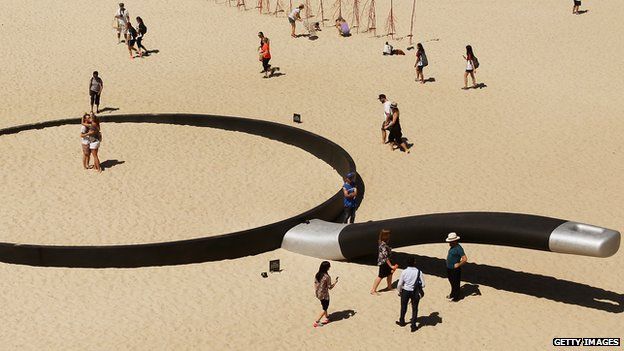 A sculpture called "We're fryin' out here" at a beach in Sydney