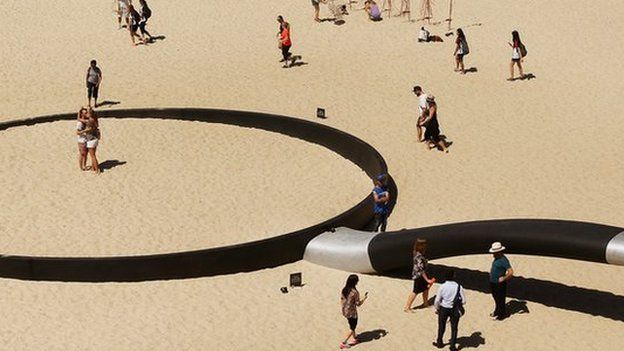 A sculpture called "We're fryin' out here" at a beach in Sydney