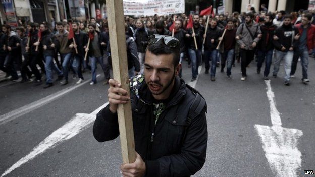 A protestor holds a banner in Greece