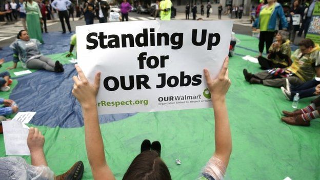 Walmart employees and supporters block off a major intersection near the Walton Family Foundation to stage a protest calling for $15 an hour and consistent full-time work in downtown Washington October 16, 2014.