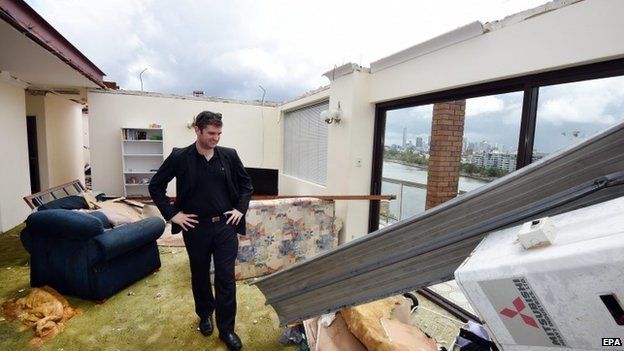 James Marriott surveys the damage in his roofless apartment in the inner city suburb of Toowong in Brisbane, Australia, 28 November 2014