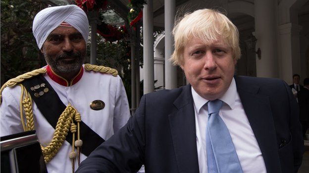 London Mayor Boris Johnson is met by Doorman, Narajan at Raffles Hotel in Singapor