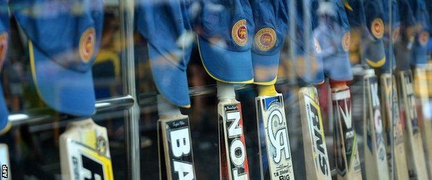 Sri Lankan bats and caps are lined up in tribute to young Australian batsman Phillip Hughes who died