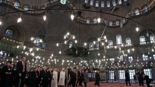 Pope Francis (L) is escorted by Mufti Rahmi Yaran upon their arrival inside the Sultan Ahmed Mosque - the Blue Mosque - in Istanbul.